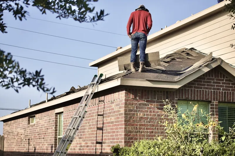 Professional roofer working on a residential roof in Downtown Bellvue